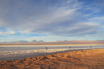 Wide landscape of Laguna Cejar salt flats in Chile with mountains