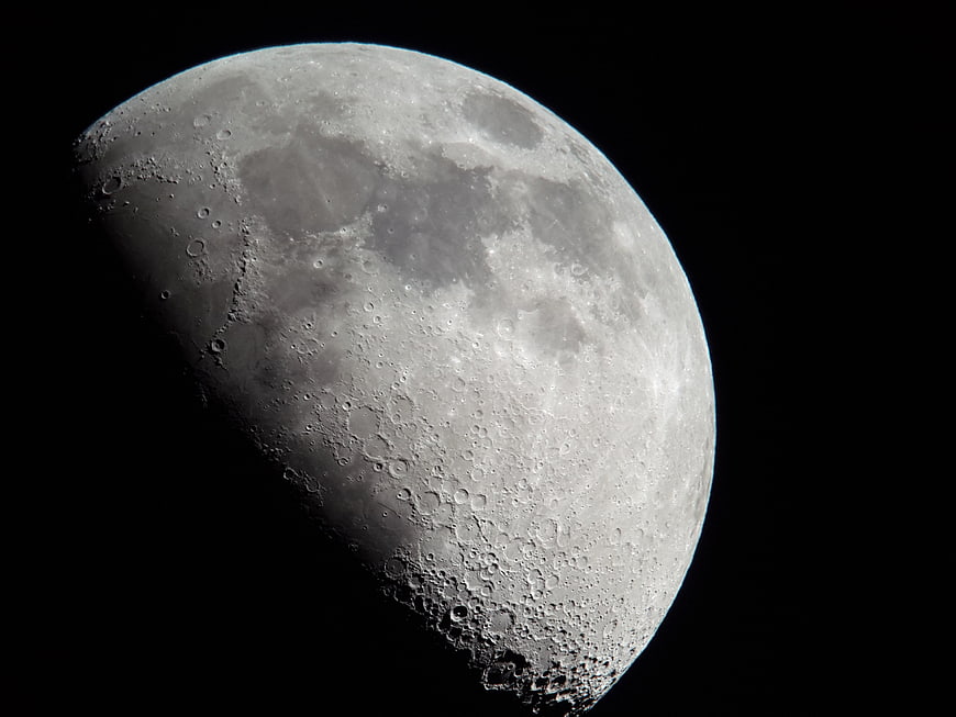 Gibbous Moon Phase With Craters Against Black Night Sky
