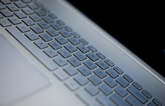 Close-up of silver laptop keyboard with black keys