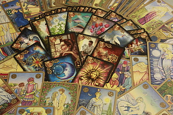 Scattered mystical oracle cards with colorful illustrations