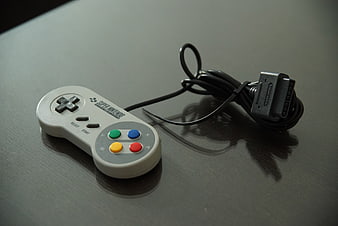 Super Nintendo Controller On Dark Surface