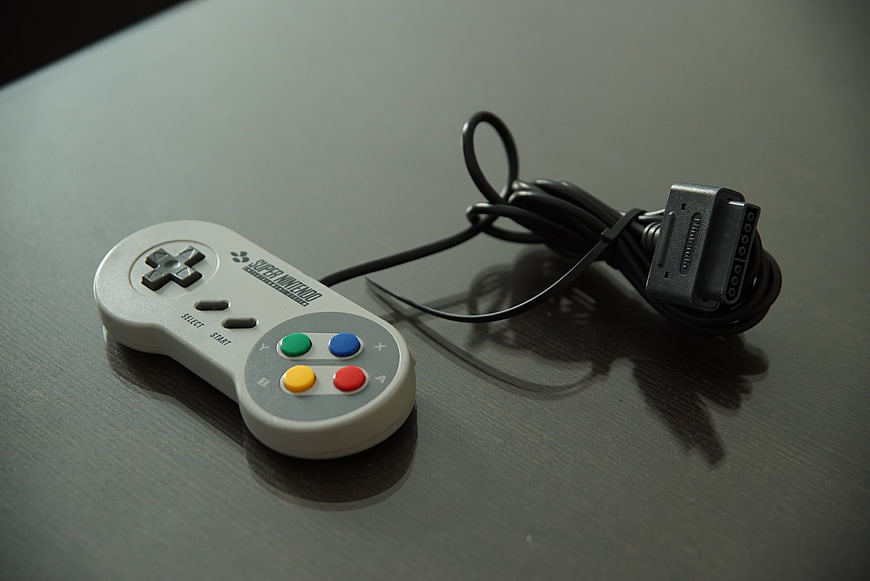 Super Nintendo Controller On Dark Surface
