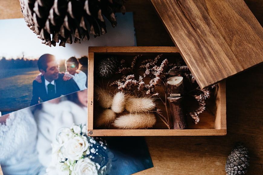 Rustic wooden box with dried flowers and wedding photos
