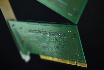 Close-up of green computer circuit board with gold connectors