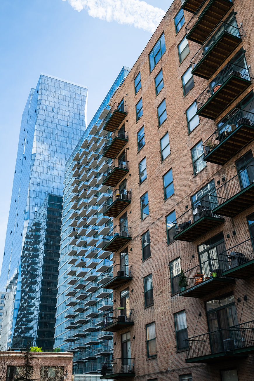 Urban Architecture Contrast: Brick Building vs Glass Skyscraper