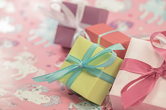 Pastel Gift Boxes with Ribbons on Pink Unicorn Wrapping Paper