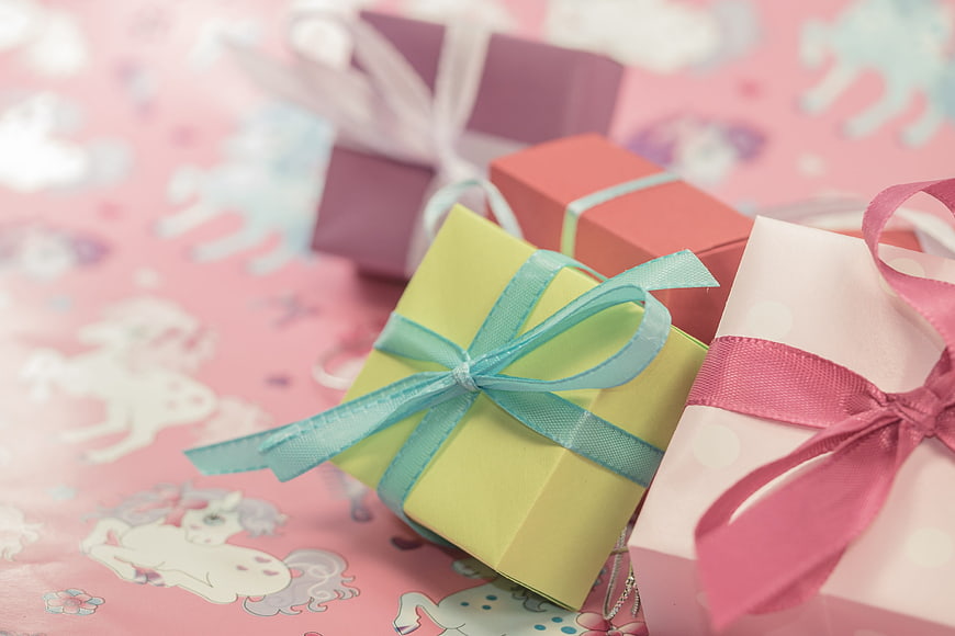 Pastel Gift Boxes with Ribbons on Pink Unicorn Wrapping Paper