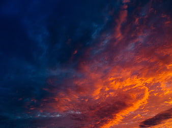 Dramatic Sunset Sky with Fiery Orange and Deep Blue Clouds