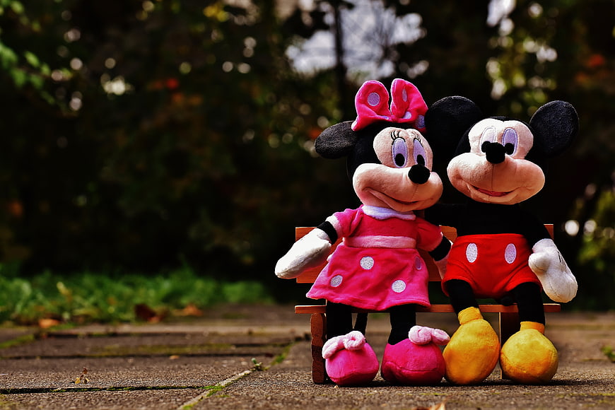 Mickey and Minnie Mouse Plush Toys Sitting on Miniature Wooden Bench