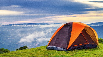 Orange Tent On Mountain Ridge Above Sea Of Clouds