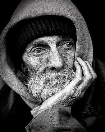 Black and white portrait of elderly man with hood and beard