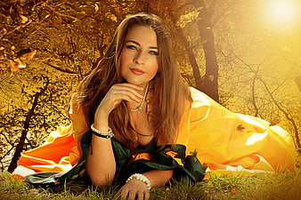 Woman in Fantasy Dress Lying in Autumn Forest