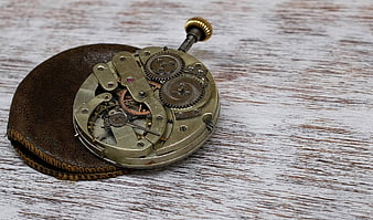 Vintage Pocket Watch Mechanism on Wooden Background