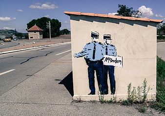Street art mural of two police officers hitchhiking to Amsterdam