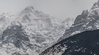 Snowy mountain peaks in foggy winter weather