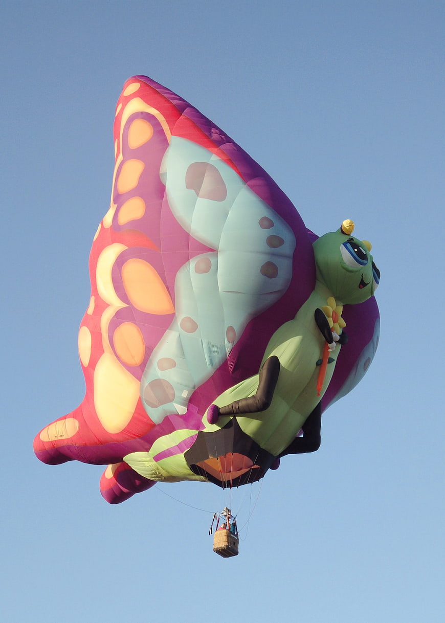 Colorful butterfly-shaped hot air balloon in blue sky