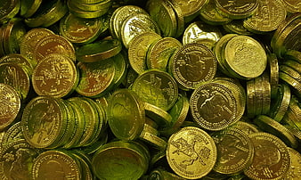 Pile of shiny gold coins with green lighting