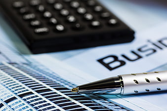 Close-up of pen and calculator on business financial report