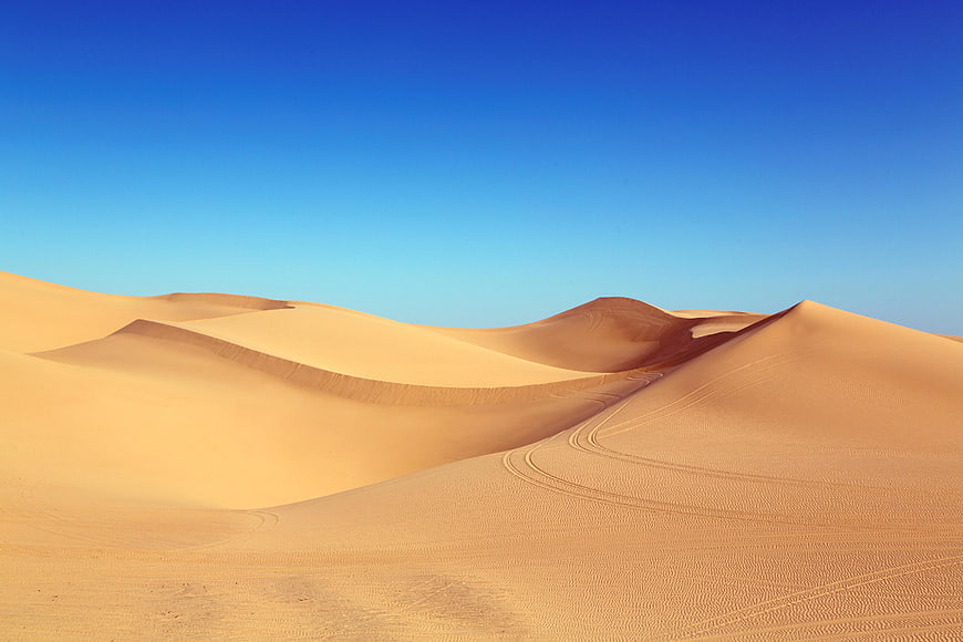 Golden Sand Dunes Under Clear Blue Sky