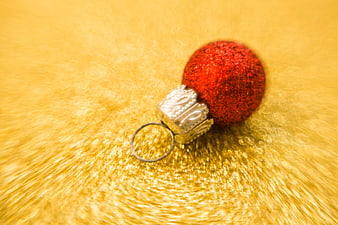 Red Glitter Christmas Ornament on Gold Background