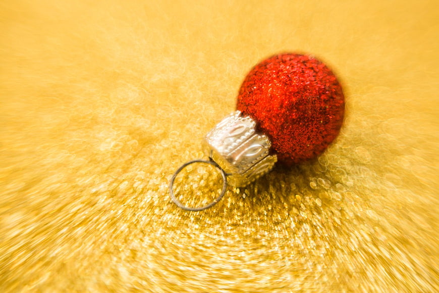 Red Glitter Christmas Ornament on Gold Background