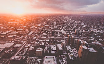Aerial View of Snowy City Skyline at Sunset