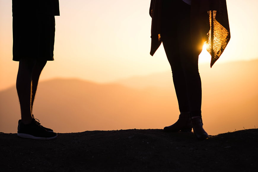 Silhouetted Couple Legs At Sunset