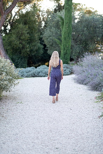 Blonde Woman Walking Away in Polka Dot Jumpsuit