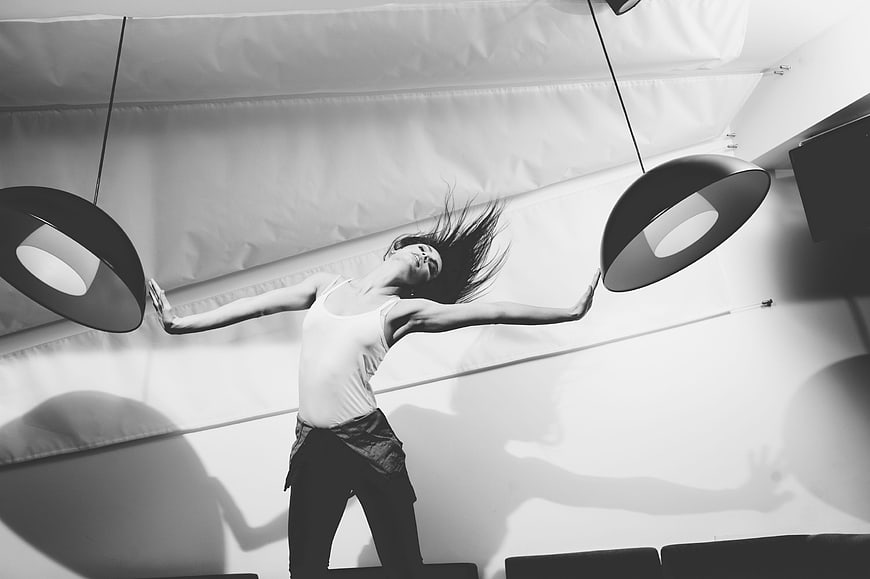Dynamic black and white photo of woman dancing with flying hair