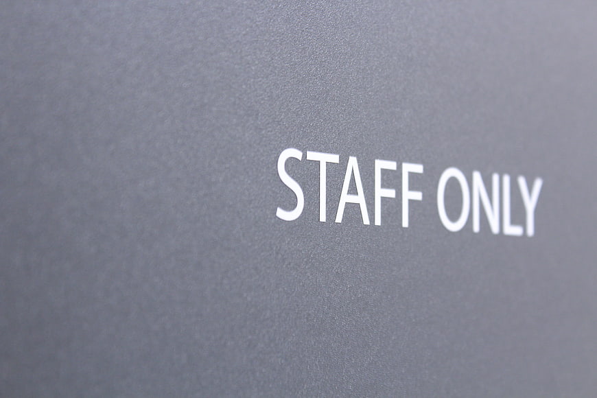 Staff Only Sign On Gray Wall