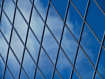Modern Glass Building Facade with Sky Reflection