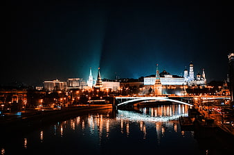 Moscow Kremlin Night Skyline with Searchlights and River Reflections