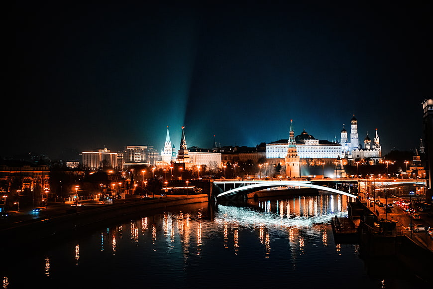 Moscow Kremlin Night Skyline with Searchlights and River Reflections
