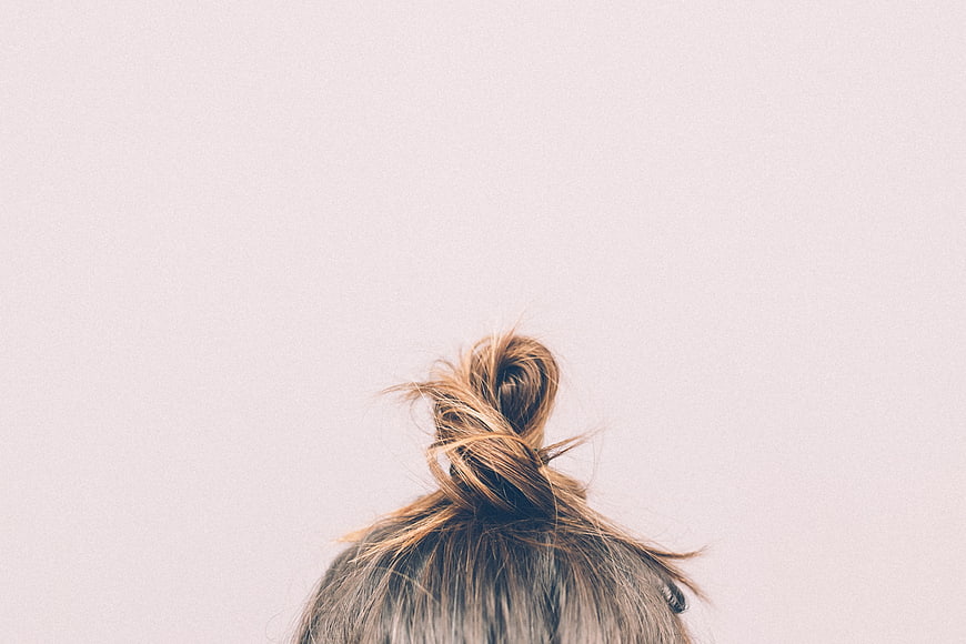 Messy Hair Bun on Minimalist Background