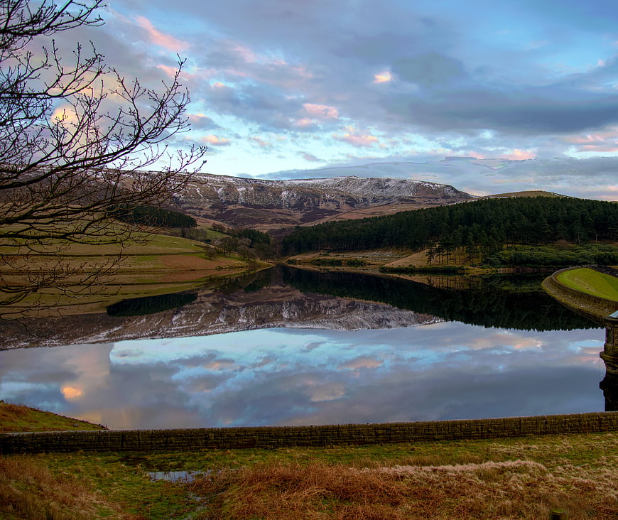 Serene Lake Reflection with Snow-Capped Hills at Sunset