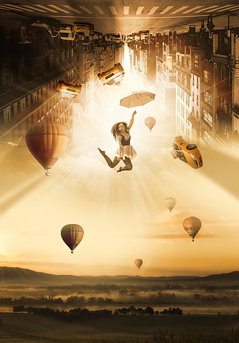 Surreal woman floating with umbrella in fantasy cityscape
