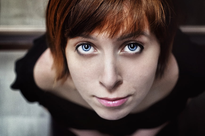 Close-up portrait of woman with blue eyes looking up