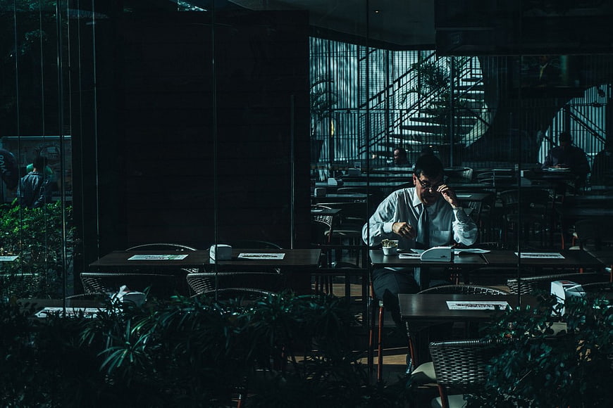 Man working late at desk in dimly lit modern office