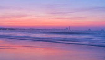 Serene pastel sunset beach landscape with smooth ocean waves