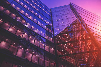Modern Glass Office Building at Sunset with Purple and Pink Gradient
