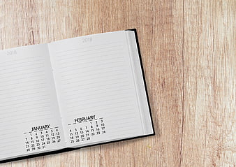 Open 2018 Planner on Wooden Desk with Copyspace