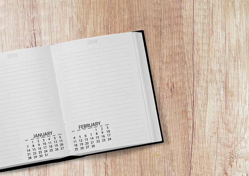 Open 2018 Planner on Wooden Desk with Copyspace