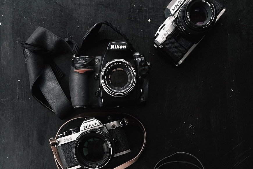 Vintage and Modern Cameras on Dark Background