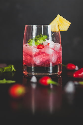 Refreshing Red Cocktail with Pineapple and Chili Garnish