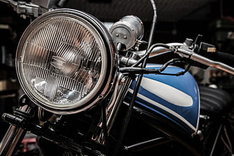 Close-up of Vintage Blue Motorcycle Headlight and Tank
