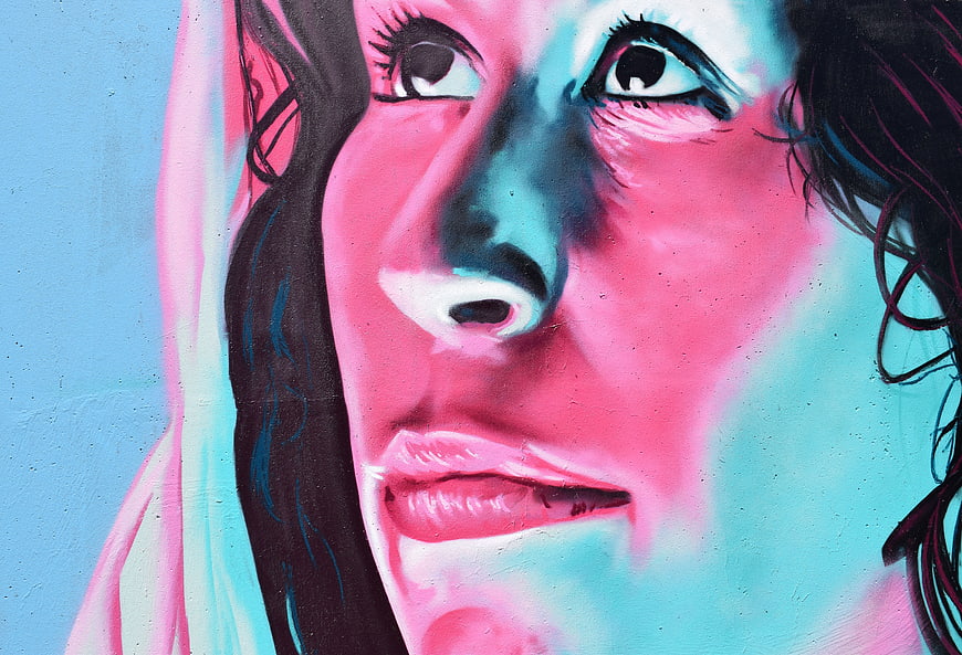 Vibrant Pink and Blue Street Art Mural of a Woman's Face