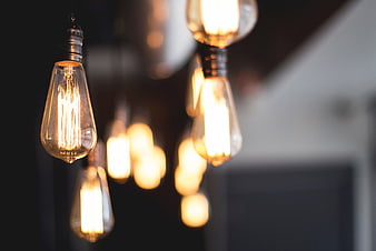 Vintage Edison light bulbs hanging in a row with bokeh