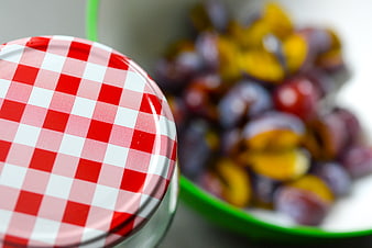 Homemade plum jam jar with fresh plums