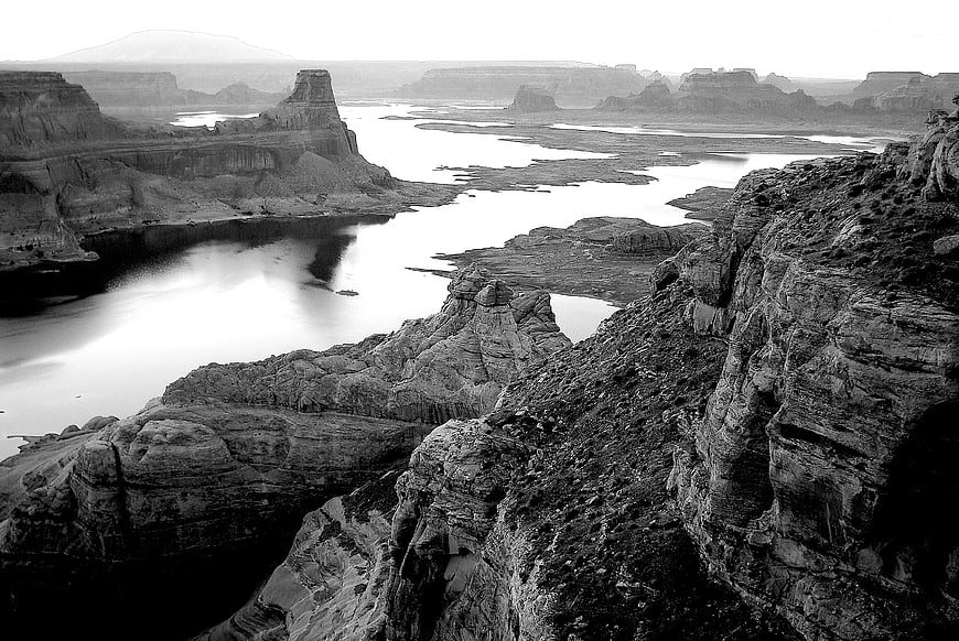 Black and white landscape of river winding through desert rock formations