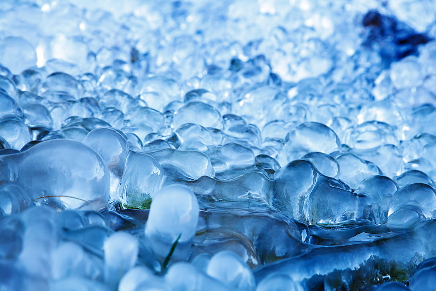 Close-up of frozen ice bubbles on a winter lake surface